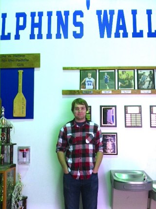 Andrew under his photo on the Wall of Fame